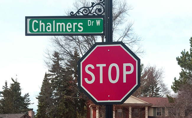 A street sign with a traffic stop sign